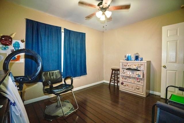 living area with ceiling fan and dark wood-type flooring