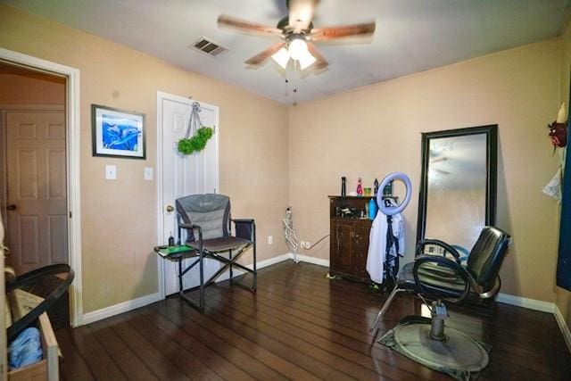 sitting room with dark hardwood / wood-style floors and ceiling fan