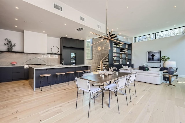 dining room with an inviting chandelier and light wood-type flooring