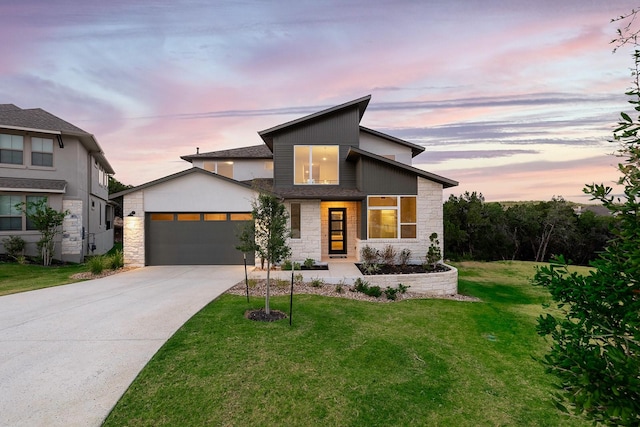 view of front of home with a garage and a yard