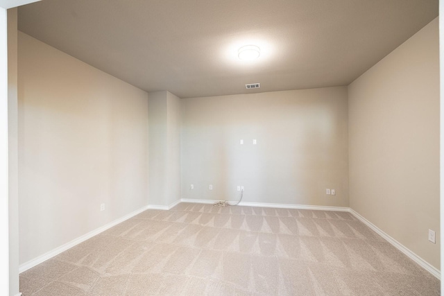 unfurnished room with light colored carpet