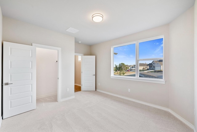 bedroom featuring light carpet and a closet