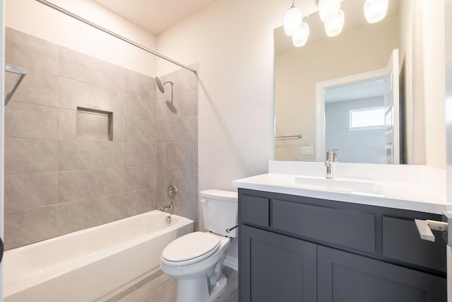 full bathroom featuring tile patterned floors, toilet, vanity, and tiled shower / bath