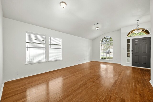 foyer featuring vaulted ceiling and hardwood / wood-style flooring