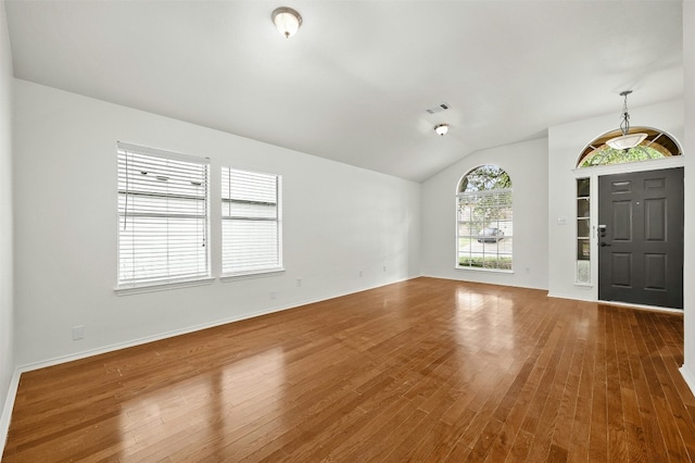 entrance foyer featuring hardwood / wood-style flooring and vaulted ceiling