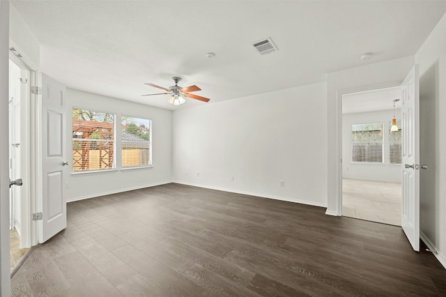 unfurnished room with ceiling fan and dark wood-type flooring