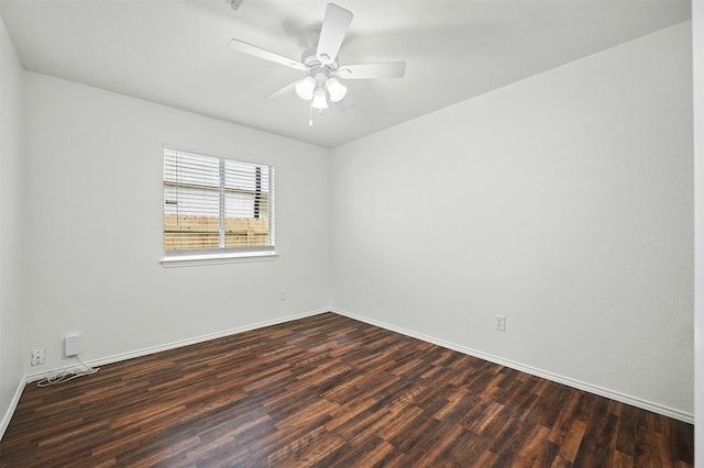 spare room with dark hardwood / wood-style flooring and ceiling fan