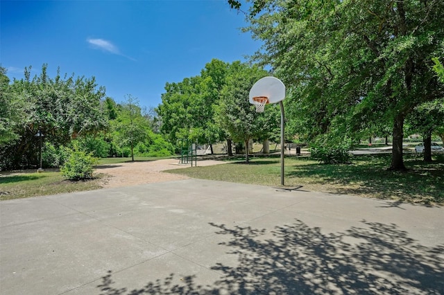 view of sport court featuring a lawn