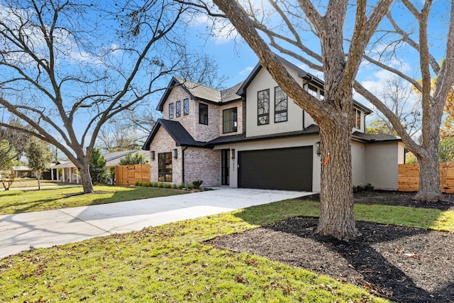 view of front of property with a garage and a front lawn