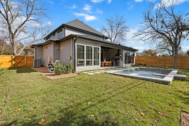 back of property featuring a lawn, area for grilling, a fenced in pool, and central AC