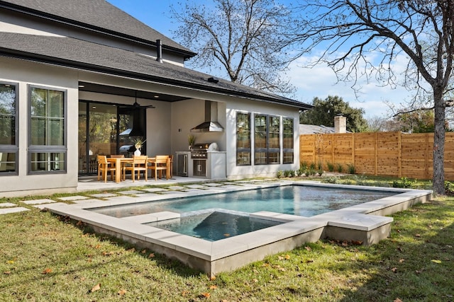 view of swimming pool with grilling area, an in ground hot tub, a patio area, and an outdoor kitchen