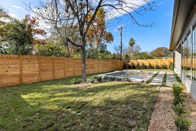 view of yard with a fenced in pool