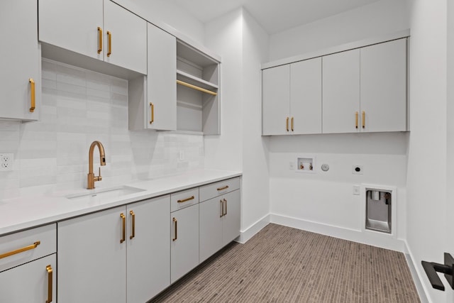 laundry area with sink, cabinets, hookup for an electric dryer, hookup for a gas dryer, and hookup for a washing machine