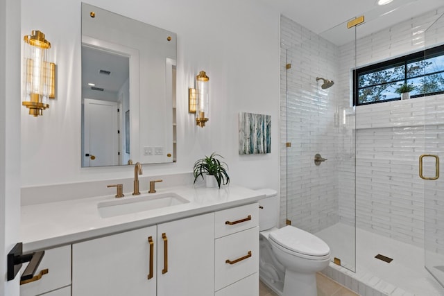 bathroom featuring tile patterned floors, vanity, toilet, and an enclosed shower