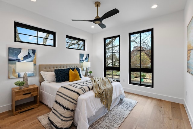 bedroom with ceiling fan and light hardwood / wood-style floors