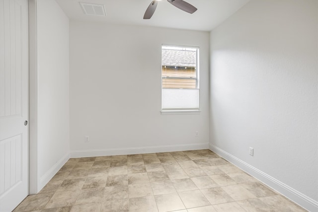 spare room featuring a ceiling fan, visible vents, and baseboards