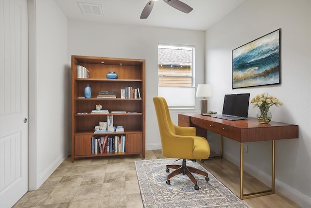 office area featuring baseboards, visible vents, and ceiling fan