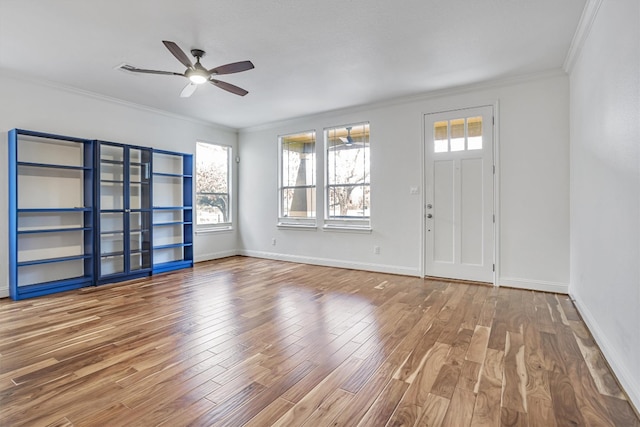 entryway featuring wood-type flooring, ornamental molding, a wealth of natural light, and ceiling fan