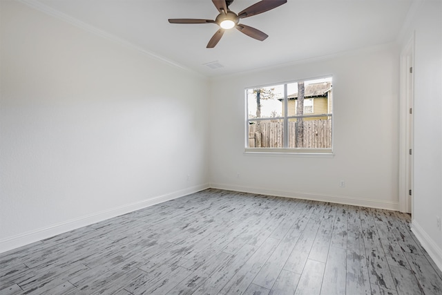 empty room featuring crown molding, ceiling fan, and light wood-type flooring