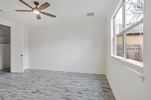 unfurnished bedroom featuring ornamental molding, a closet, and ceiling fan