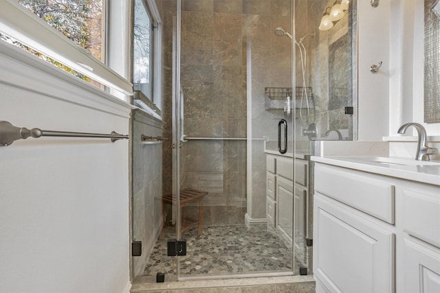 bathroom with a shower stall and vanity