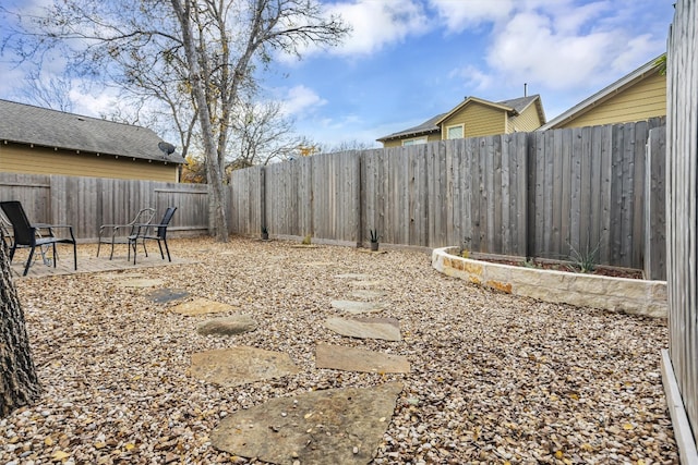 view of yard with a fenced backyard and a patio