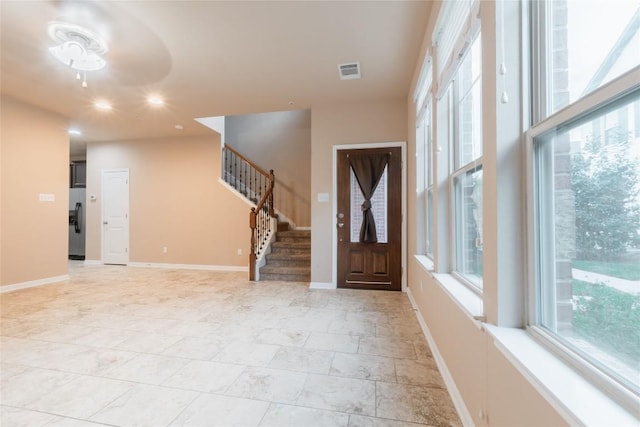 foyer featuring ceiling fan