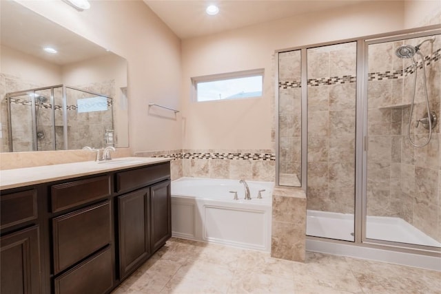 bathroom featuring vanity and separate shower and tub