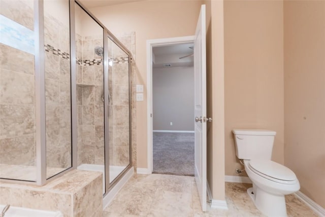 bathroom featuring toilet and a shower with door