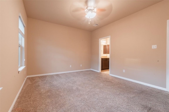 unfurnished room featuring ceiling fan and light colored carpet