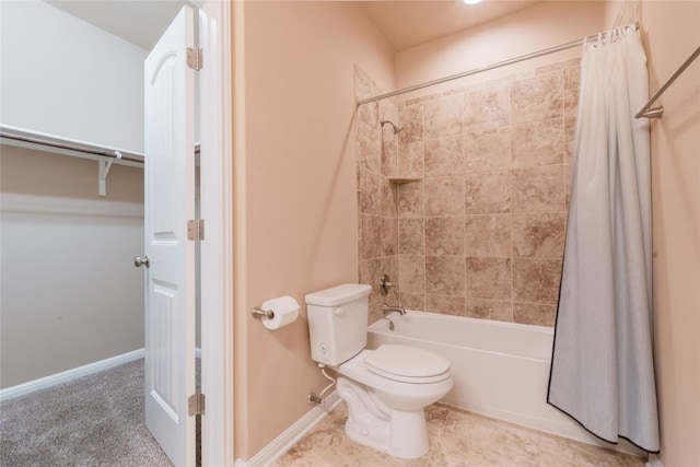 bathroom with tile patterned floors, shower / bath combo, and toilet