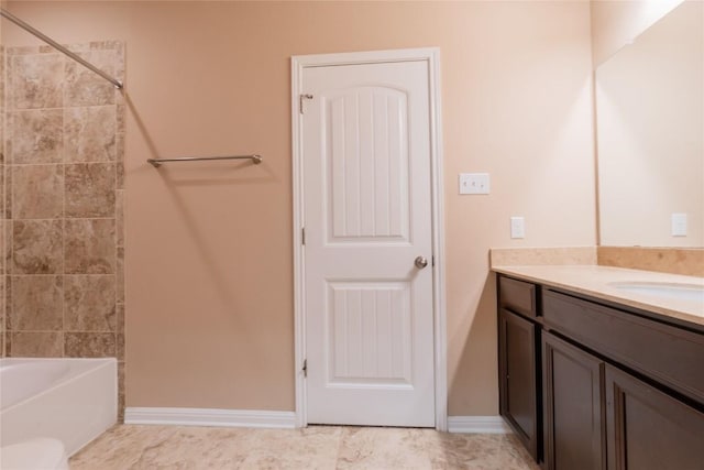 bathroom featuring vanity and tiled shower / bath