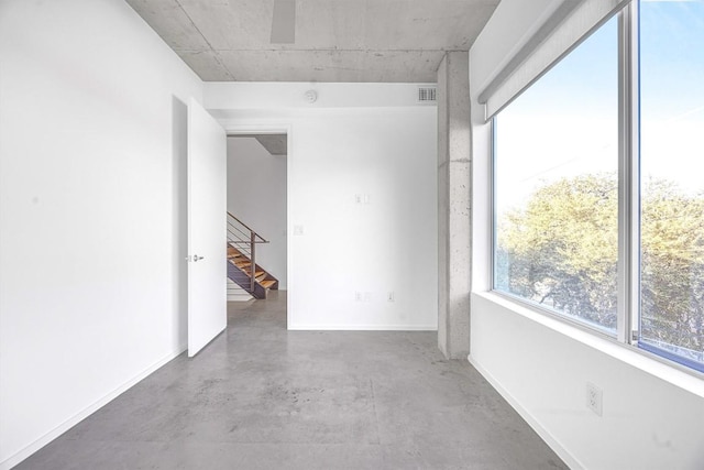 unfurnished room featuring concrete floors