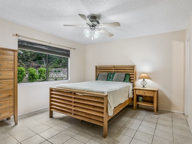 bedroom featuring light tile patterned floors, a textured ceiling, and ceiling fan