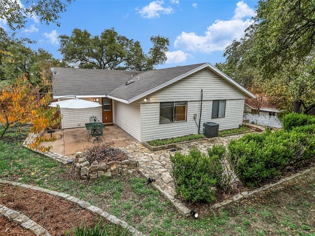 rear view of house with a patio area and central AC