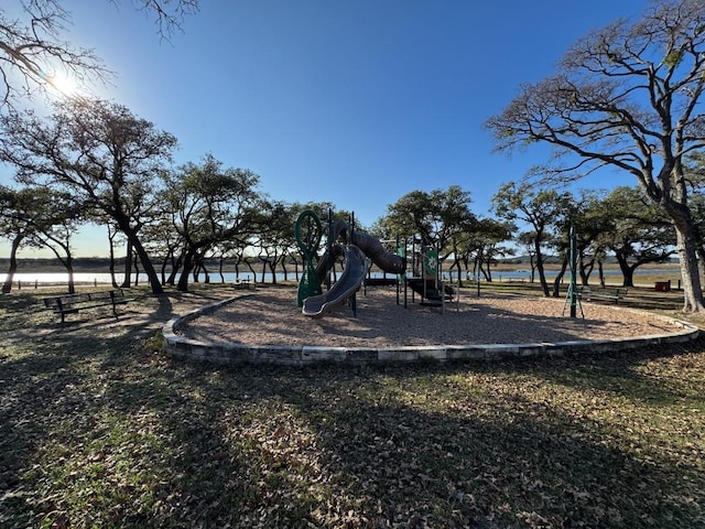 view of playground with a water view