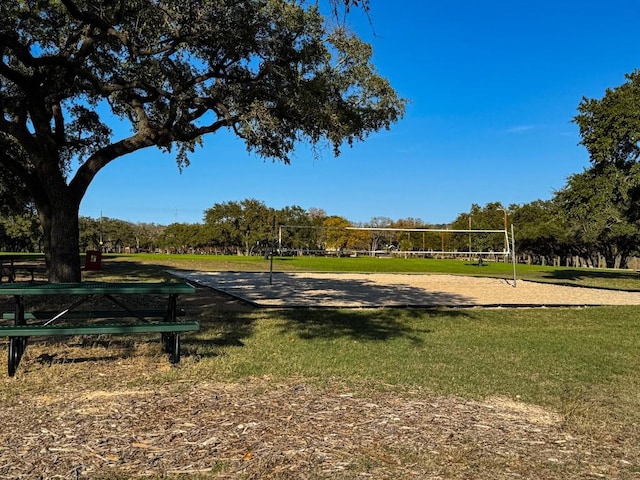 view of home's community with volleyball court and a yard