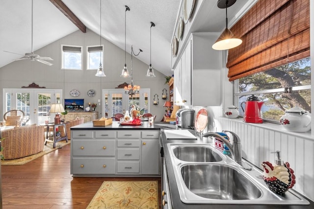 kitchen with french doors, dark hardwood / wood-style flooring, high vaulted ceiling, gray cabinets, and hanging light fixtures