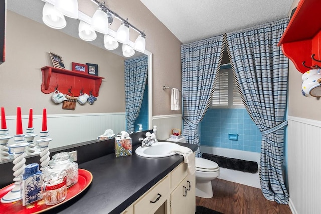 bathroom with a textured ceiling, vanity, hardwood / wood-style flooring, and toilet