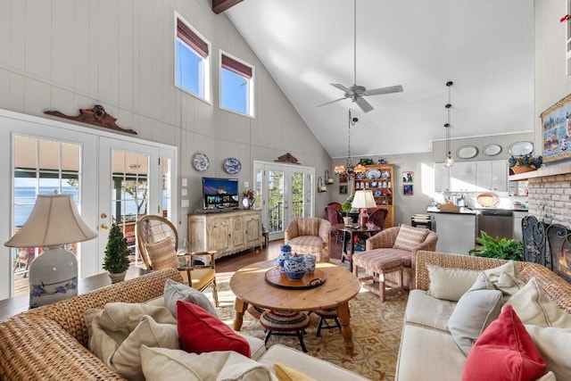 living room with high vaulted ceiling, french doors, a brick fireplace, ceiling fan, and wood-type flooring