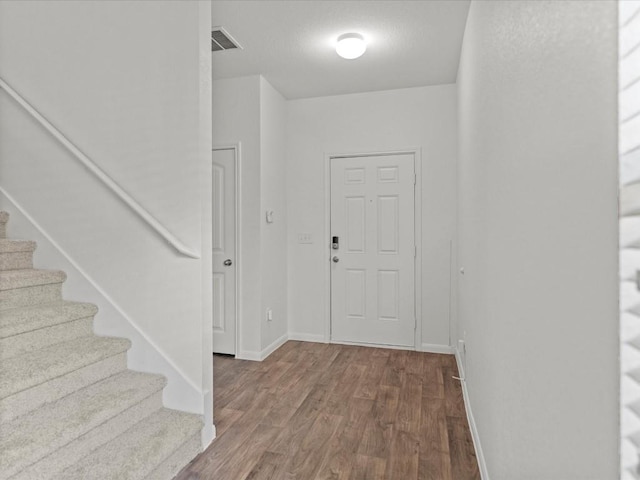 entryway with hardwood / wood-style floors