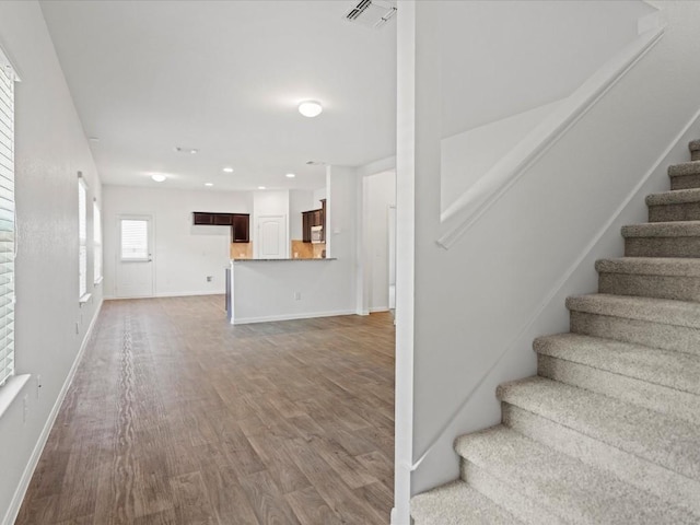 stairway featuring wood-type flooring