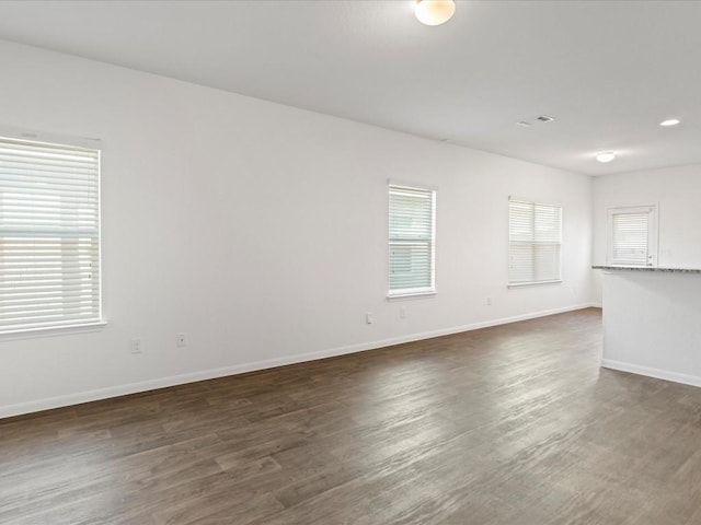 spare room featuring dark hardwood / wood-style floors