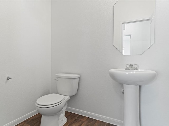 bathroom featuring hardwood / wood-style floors and toilet