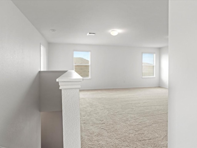 carpeted spare room with plenty of natural light