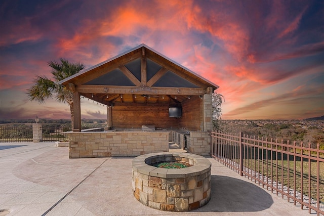 view of patio featuring a gazebo, a grill, and an outdoor fire pit