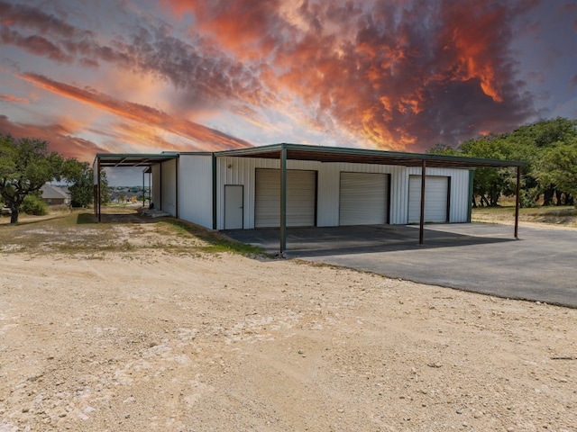 view of garage at dusk