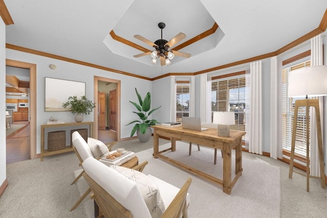 home office with light carpet, a tray ceiling, and a wealth of natural light