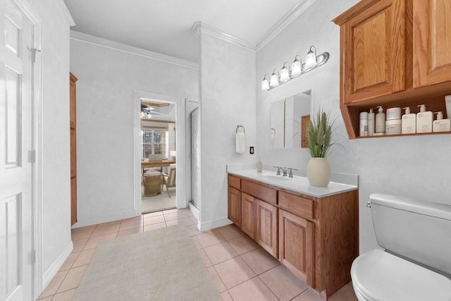 bathroom featuring ceiling fan, tile patterned flooring, toilet, vanity, and ornamental molding