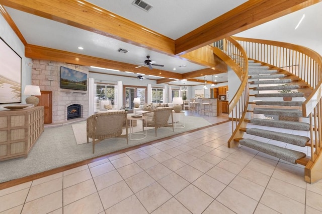 unfurnished living room with beamed ceiling, ceiling fan, light tile patterned flooring, and a fireplace